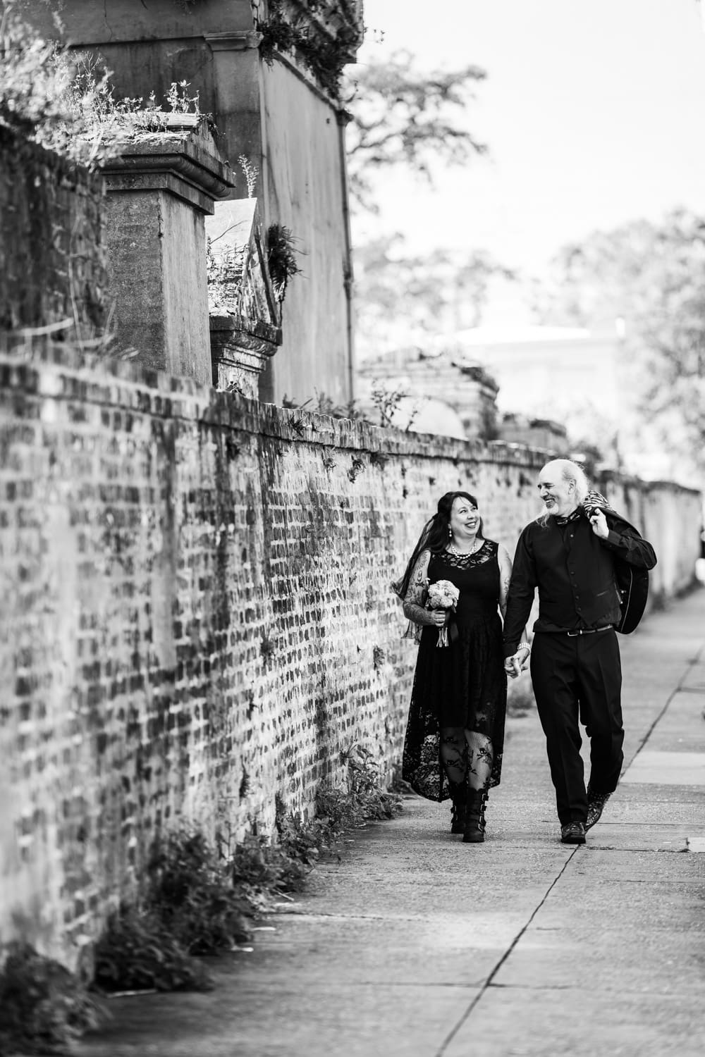 Eloping couple walking near cemetery