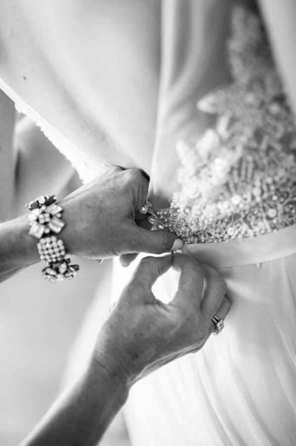 Bride's dressing being buttoned