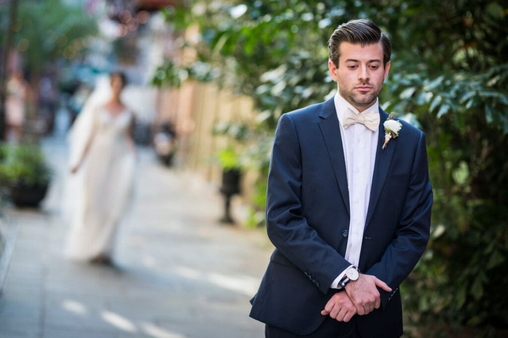 Groom waits for first look with bride in French Quarter