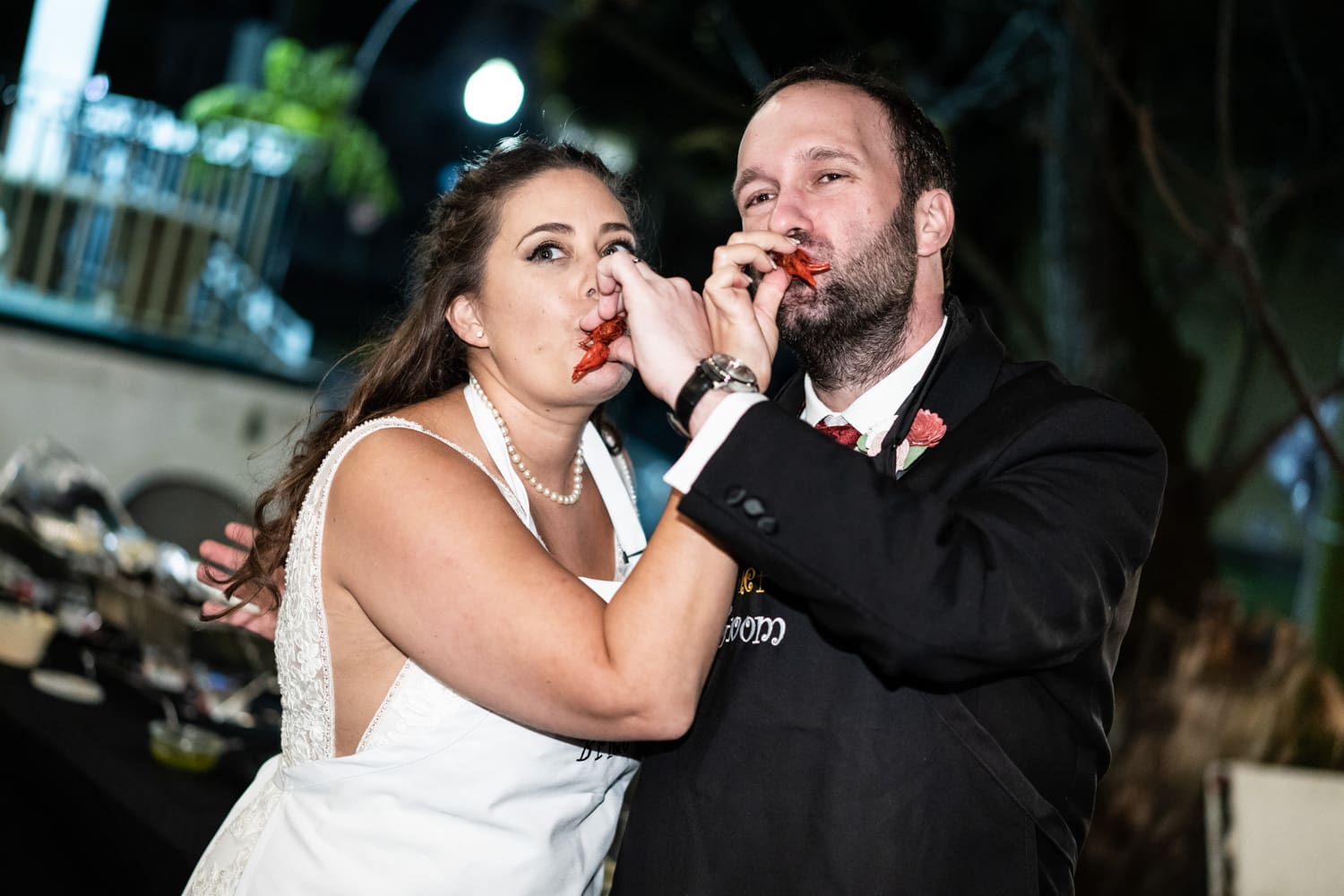 Bride and groom sucking crawfish heads