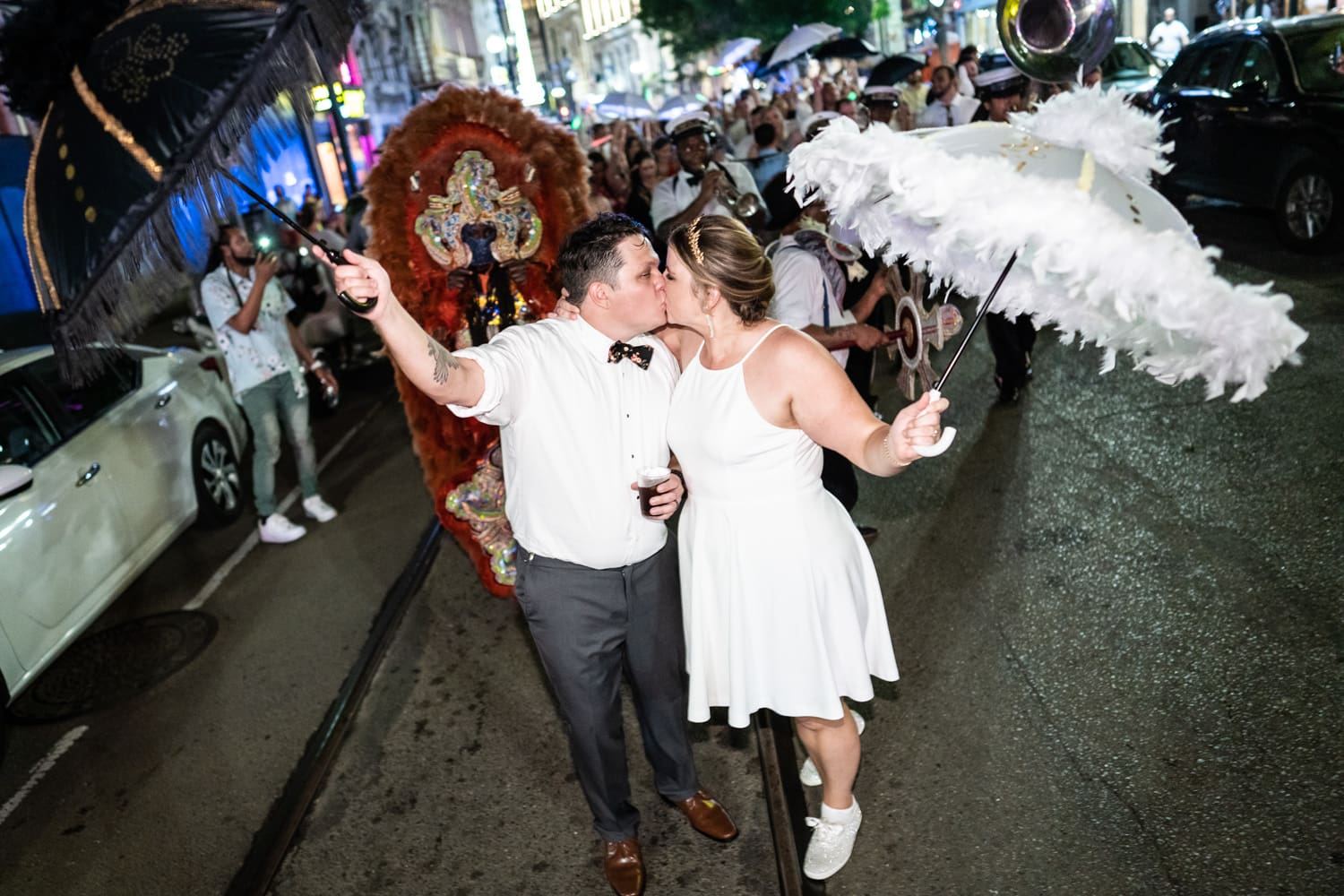 Bride and groom with umbrellas in New Orleans wedding parade