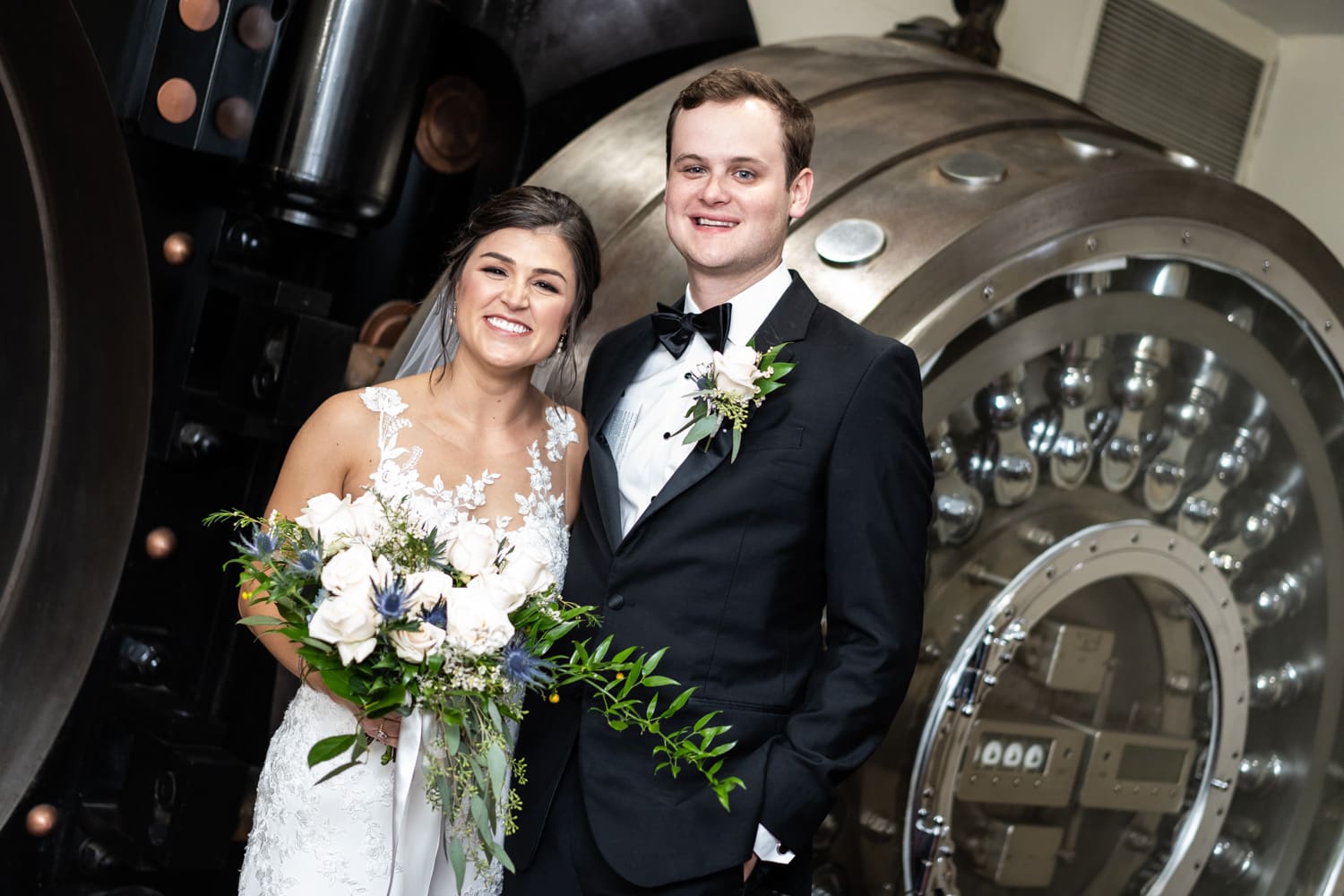 Bride and groom in front of vault door at Federal Ballroom wedding