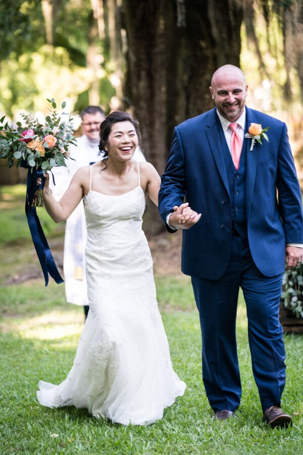 Bride and groom walk down the aisle