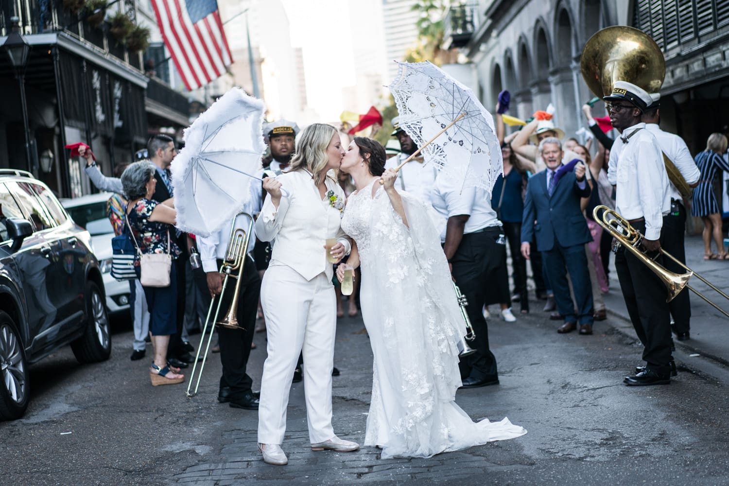 Brides kiss during second line parade through the French Quarter