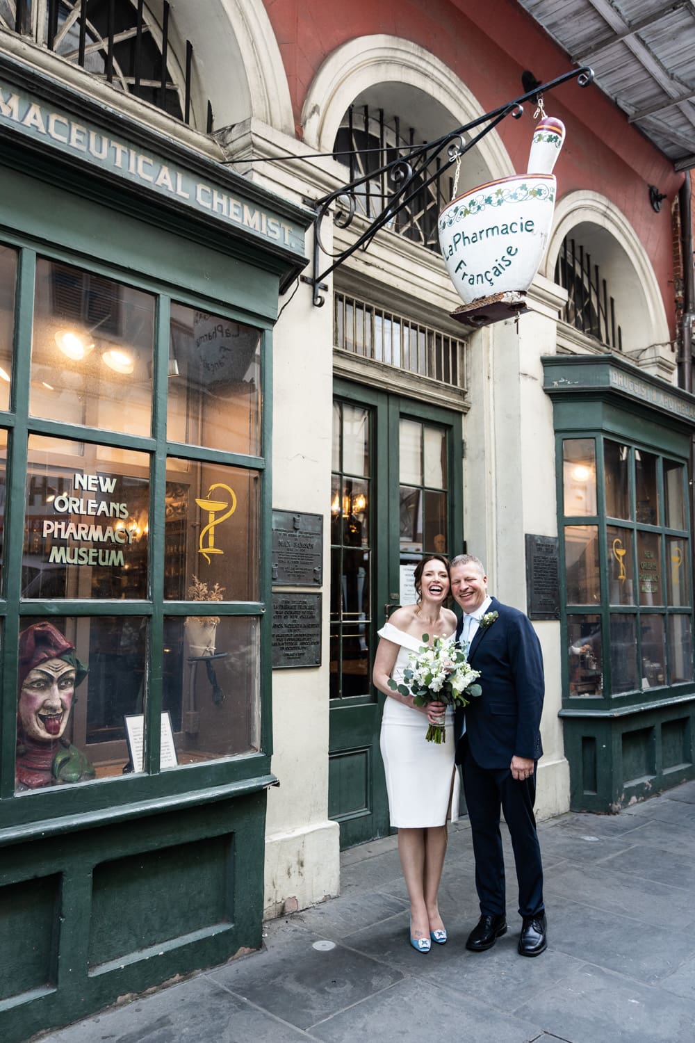 Bride and groom in front of Pharmacy Museum in New Orleans