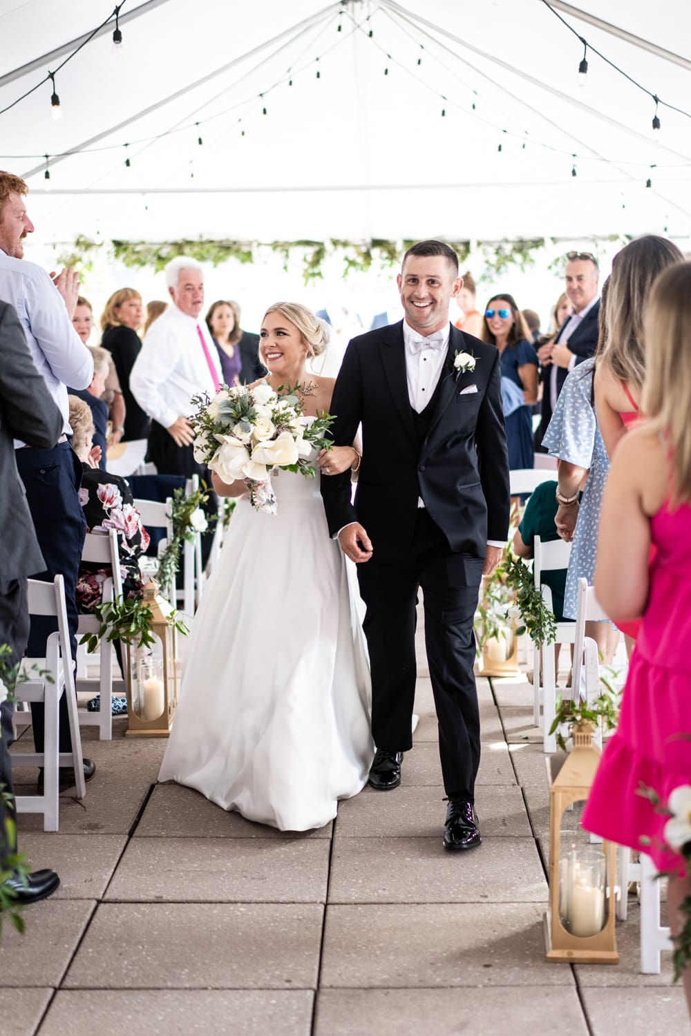 Bride and groom walking down aisle at the end of outdoor wedding ceremony at the Riverview Room