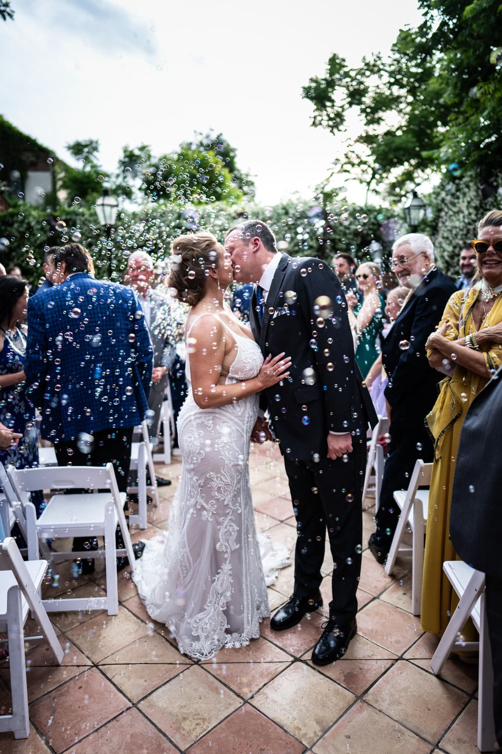 Couple kissing amidst bubbles at Rosy's Jazz Hall wedding