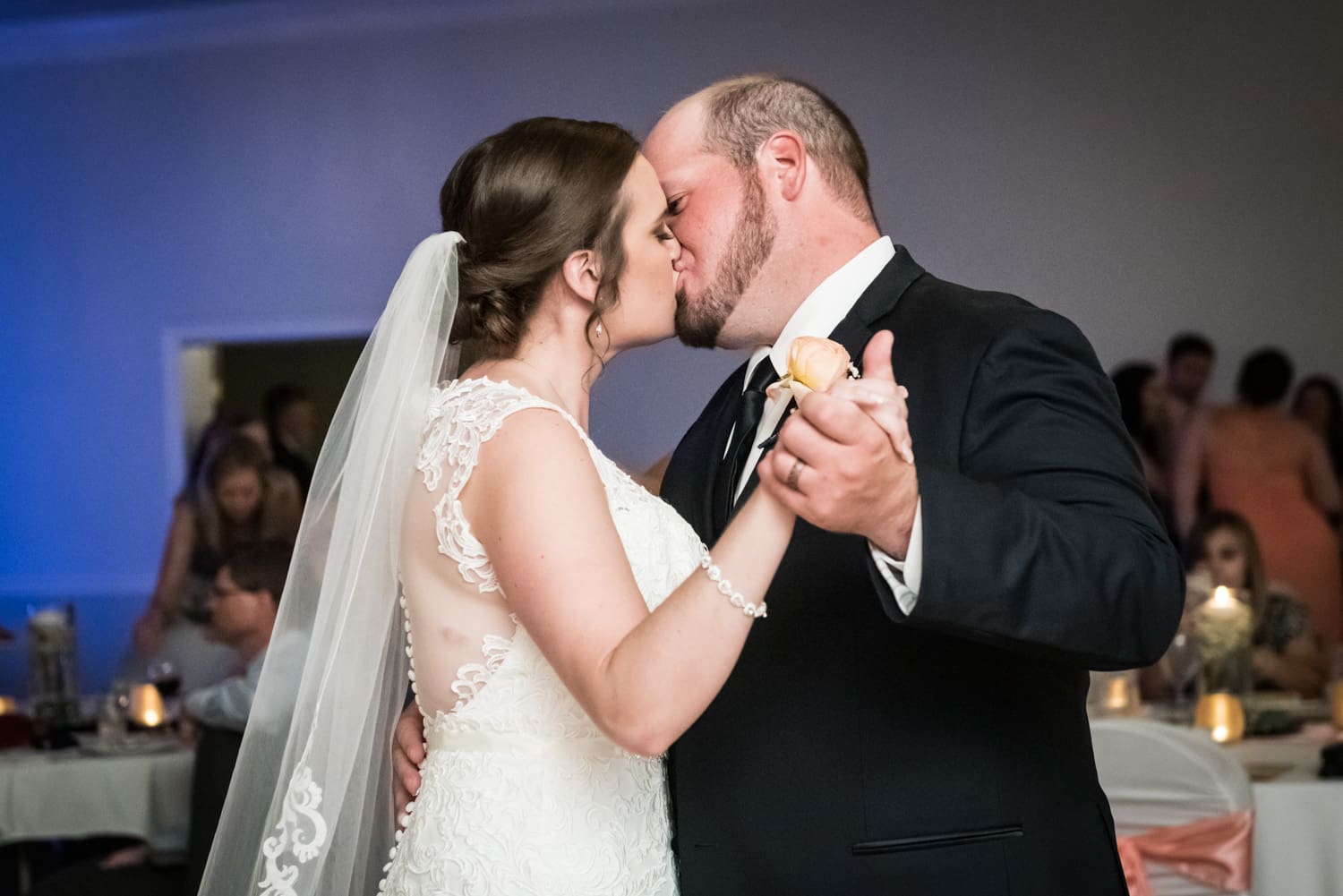 Couple kisses during first dance at Trinity wedding in Slidell