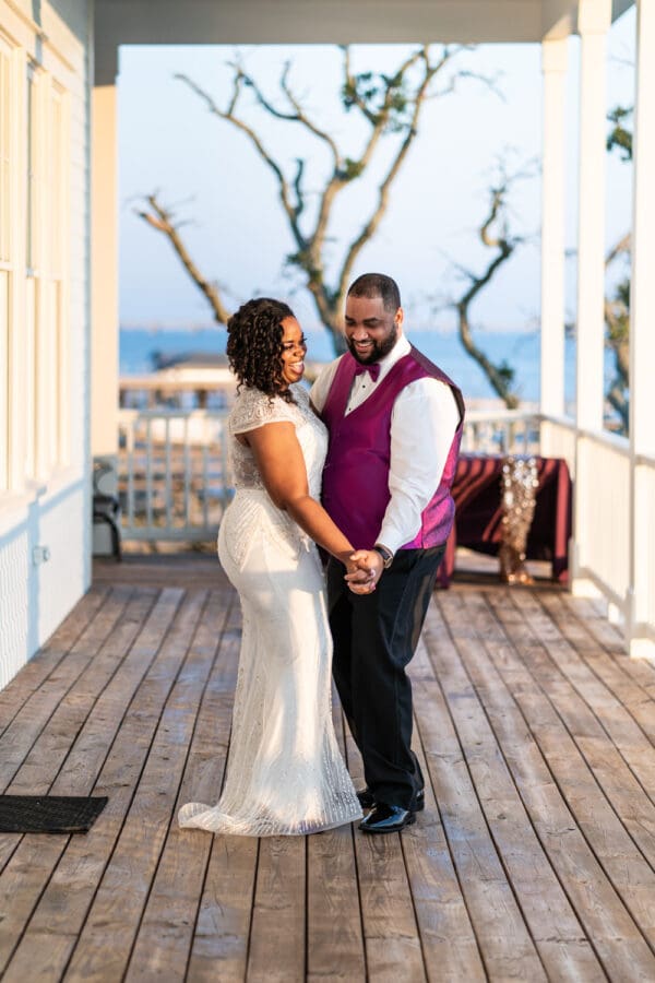 Bride and groom dancing on balcony at Slidell wedding