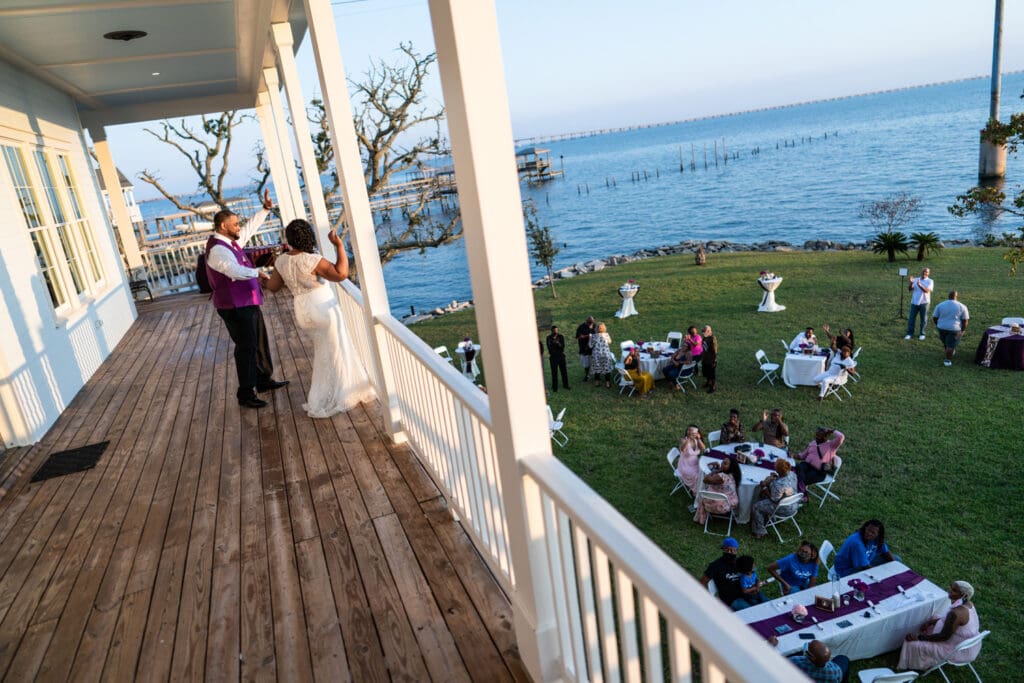 Bride and groom waiving to guests at Slidell wedding