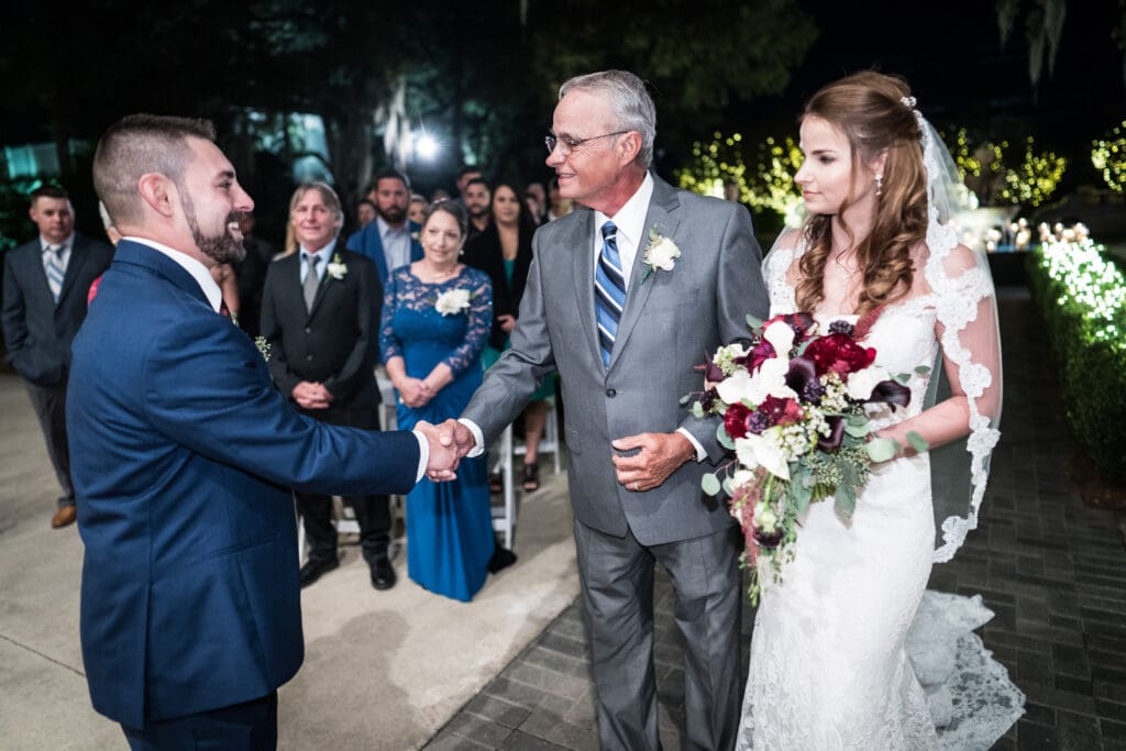 Bride's father shakes the groom's hand