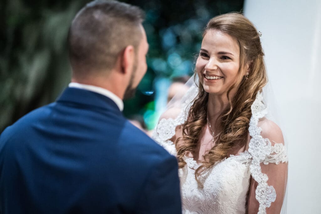 Bride smiles at groom