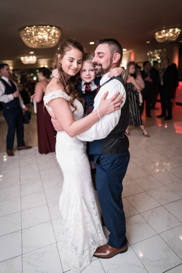 Bride and groom dancing with their son