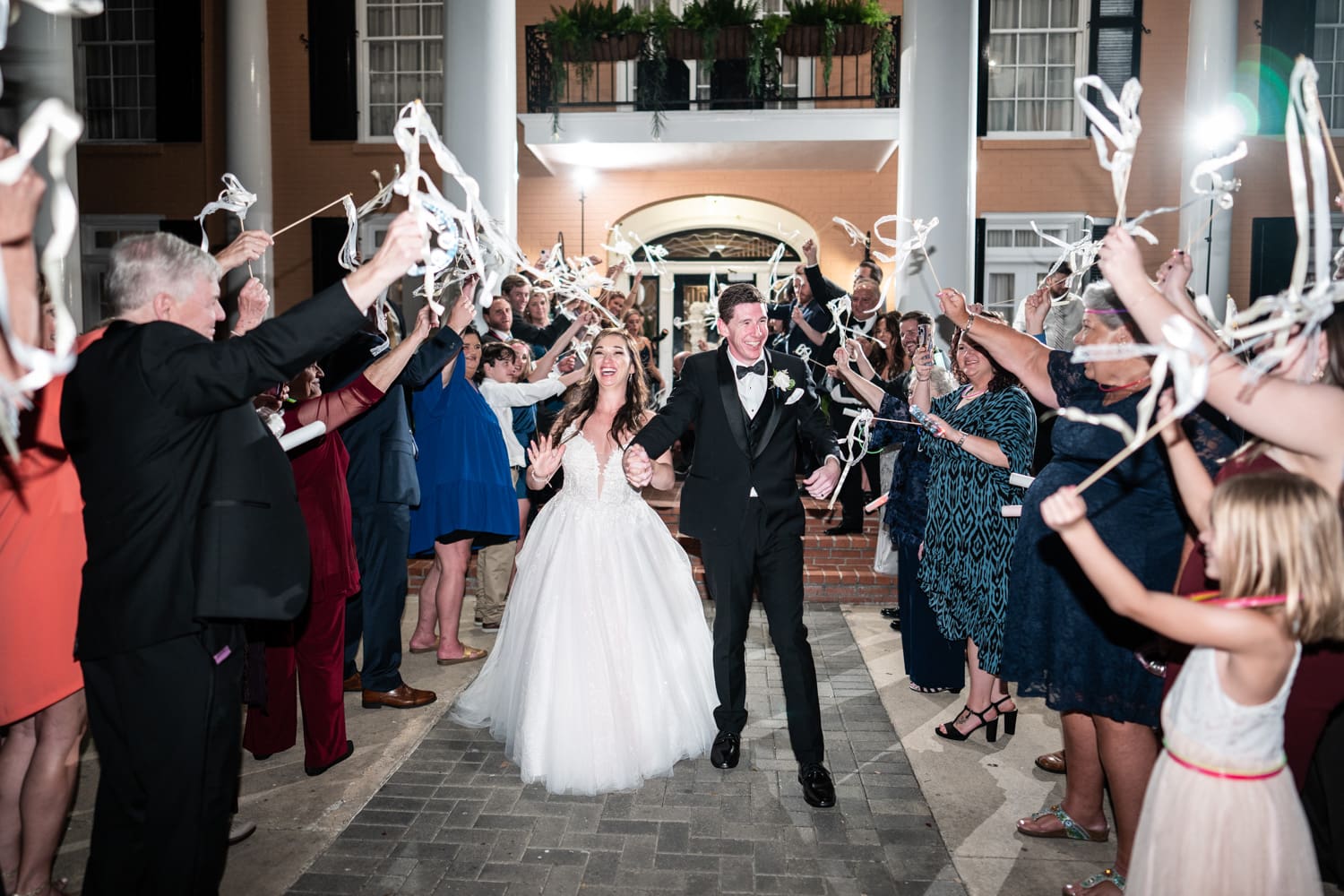 Couple having streamer stick send-off at Southern Oaks wedding