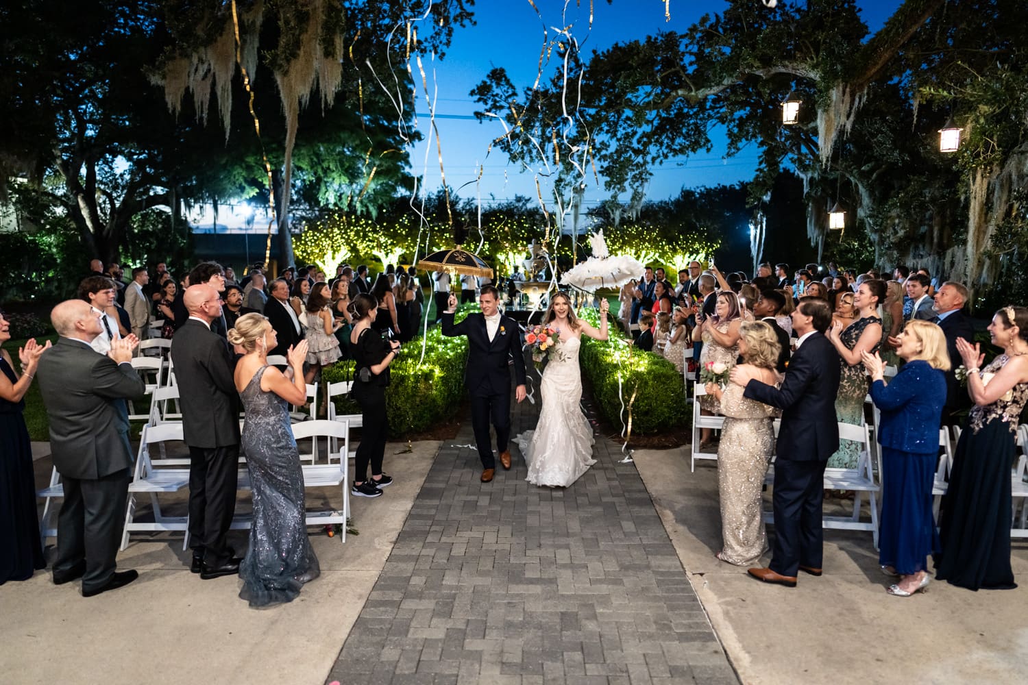 Bride and groom with umbrellas at Southern Oaks wedding