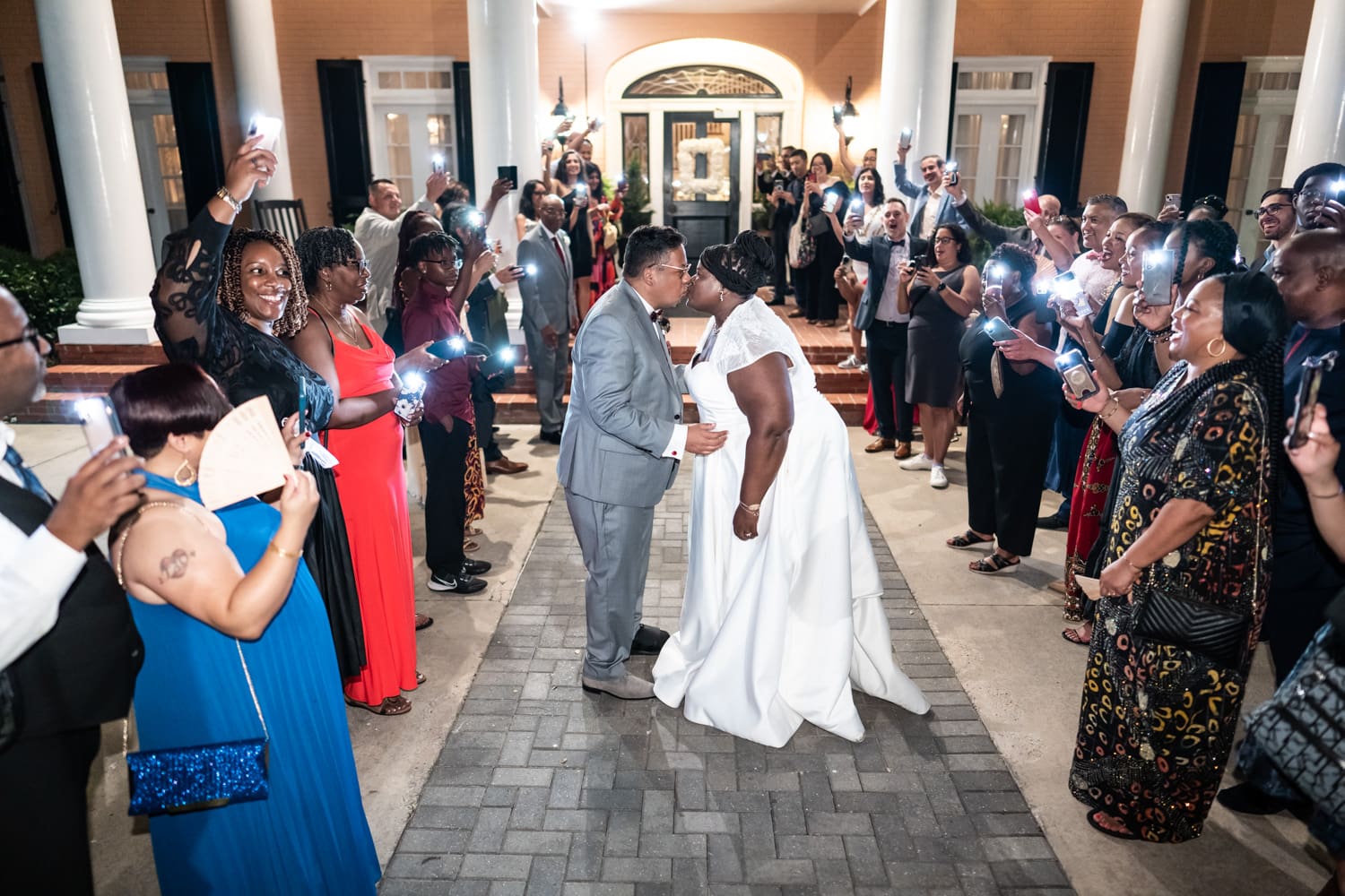 Bride and groom kissing during send-off at wedding