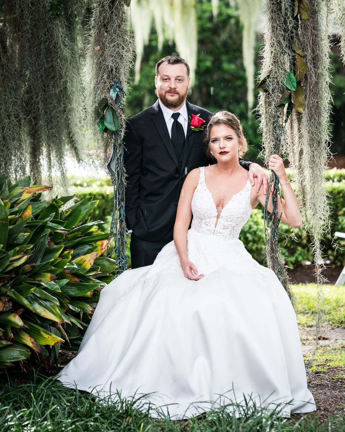 Bride and groom by swing at Southern Oaks