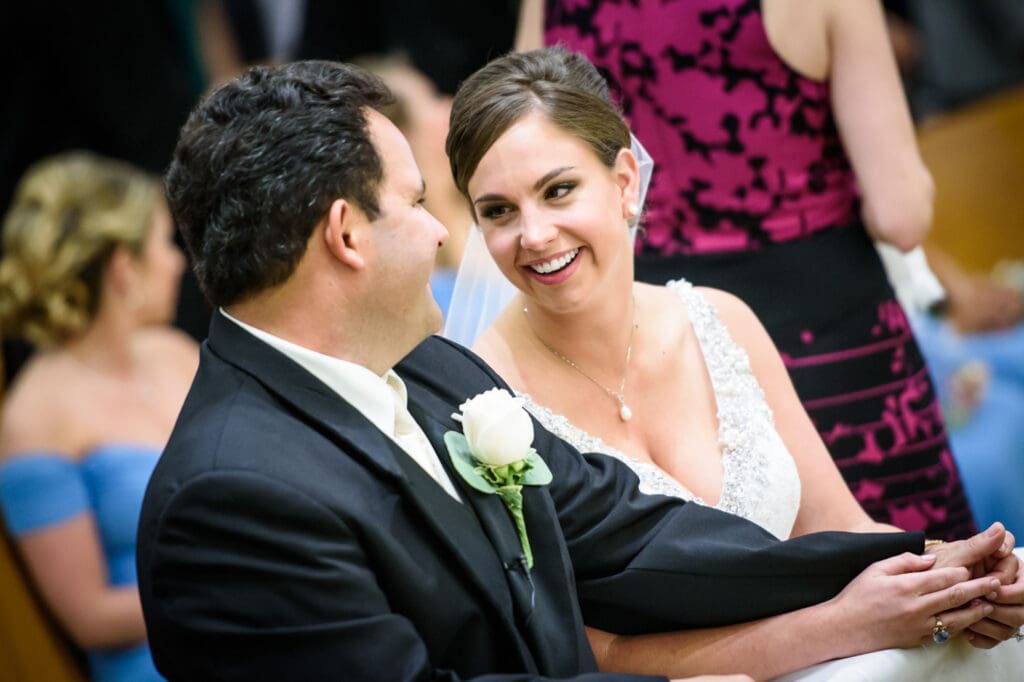 Bride smiling at groom at St. James in Gulfport