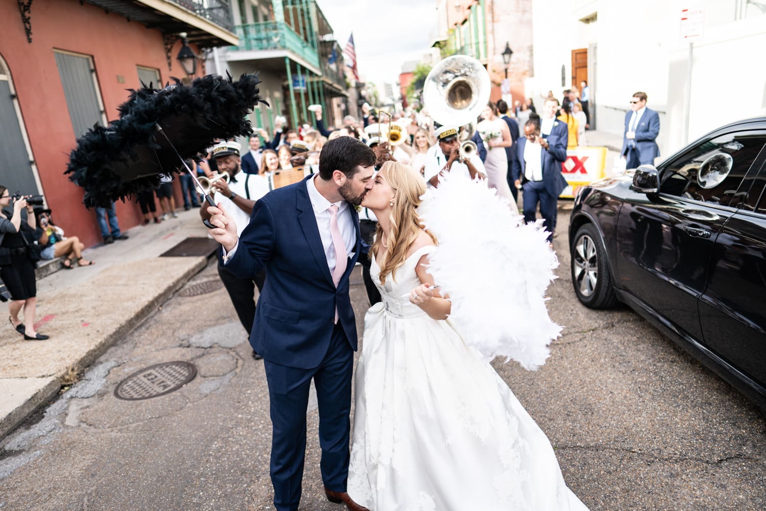 Bride and groom kissing during wedding second line parade in the French Quarter