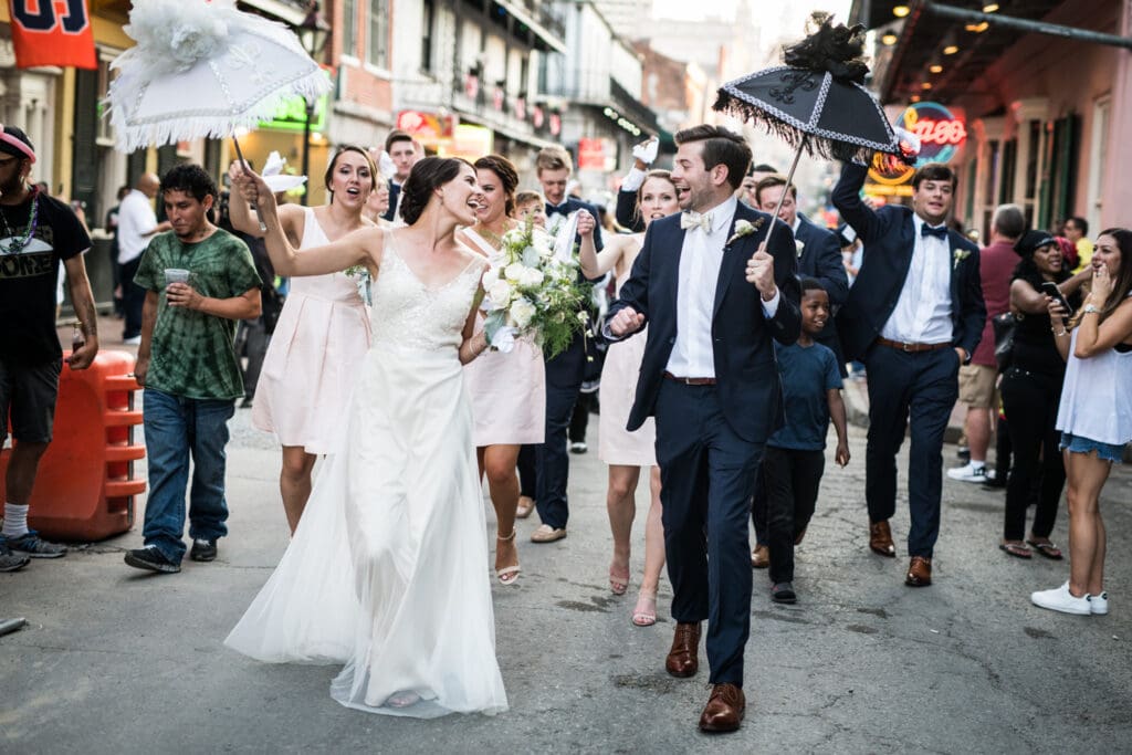 Bride and groom second line parade through the French Quarter