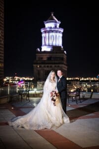 Bride and groom on top of Capital on Baronne wedding venue with Hibernia Building in background