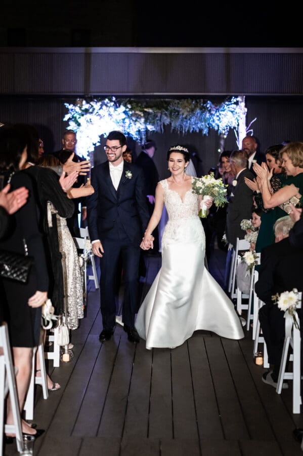 Bride and groom walk down the aisle after Capulet wedding ceremony