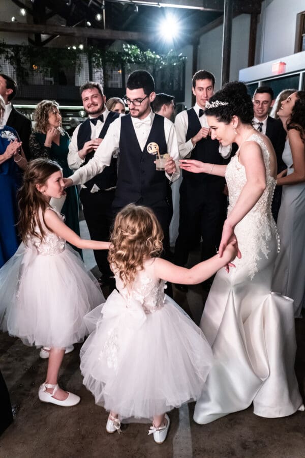 Bride and groom dancing with flower girls at Capulet