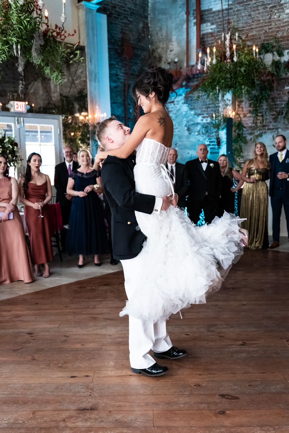 Groom lifts bride at Gallery Venue at Tomas Bistro wedding first dance