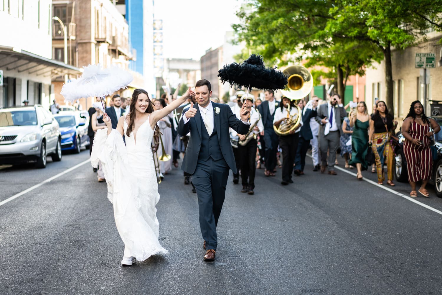 Bride and groom parading down the street in New Orleans