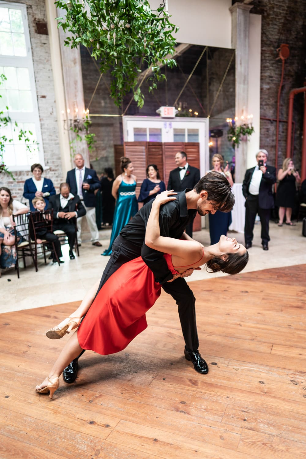 Groom dips bride during first dance at Gallery Venue at Tomas Bistro