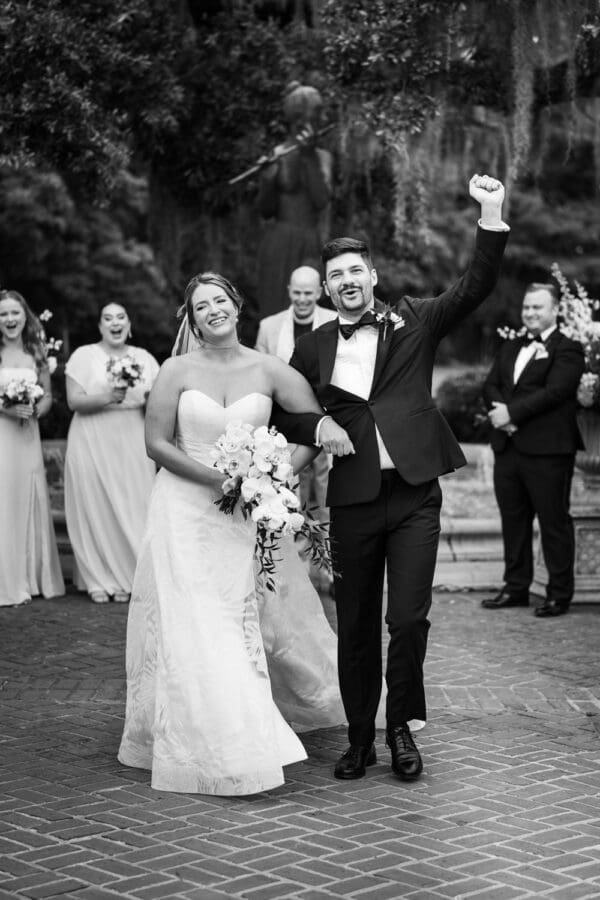 Bride and groom celebrate after Camellia Gardens wedding ceremony