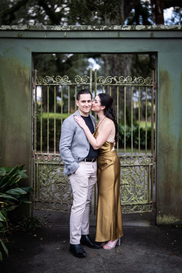 Couple in front of garden gate during Houmas House engagement portrait