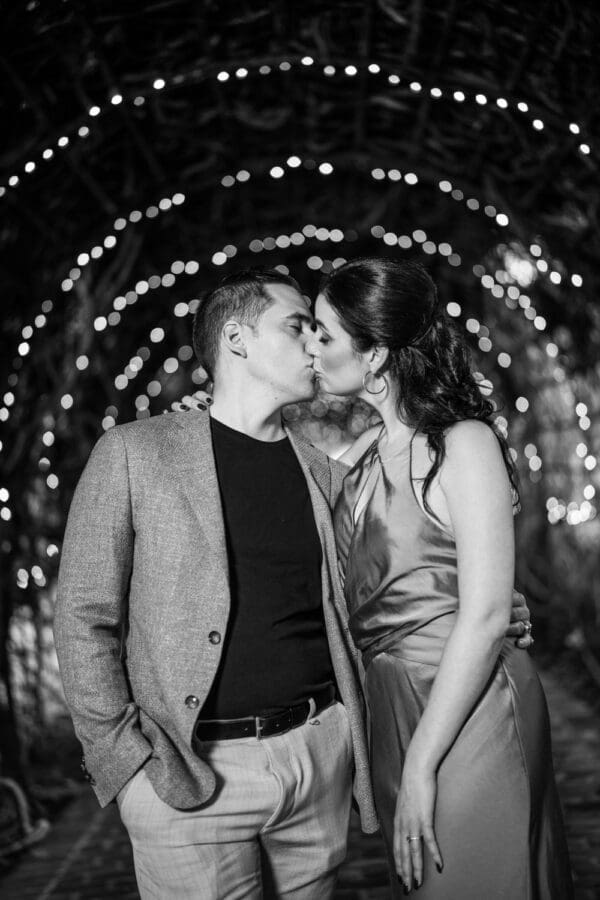 Couple with archway of lights in the background