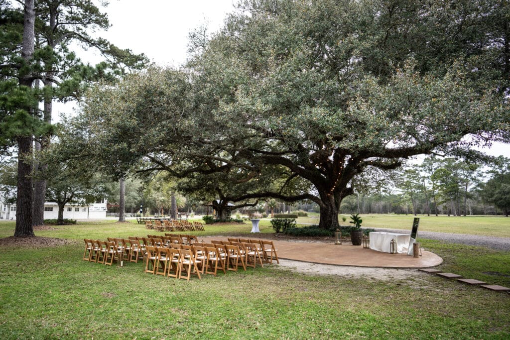 Wedding ceremony setup by oak tree at Garrett Field
