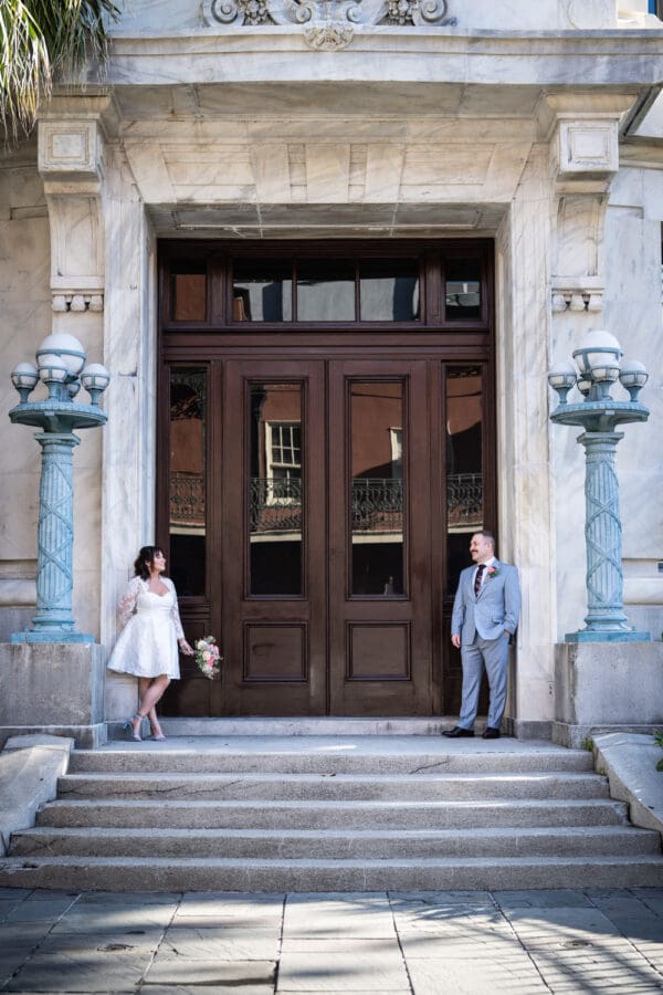 Bride and groom in front of Supreme Court building in New Orleans