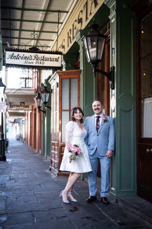 Bride and groom in front of Antoine's Restaurant in New Orleans