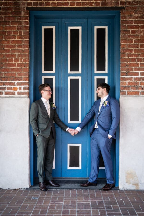 Two grooms standing in doorway