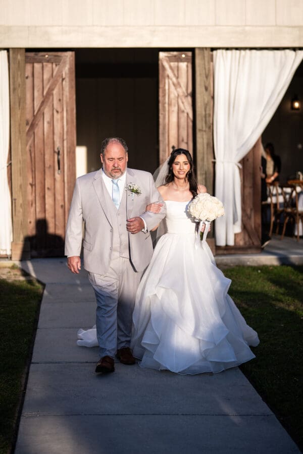 Bride and father walk up the aisle
