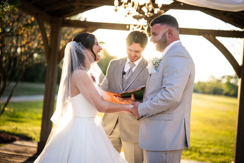 Bride and groom smile during Sadie Jane wedding ceremony