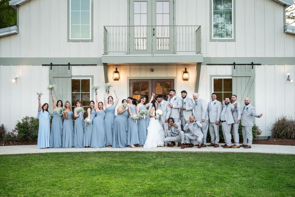 Couple and groomsmen in front of Sadie Jane