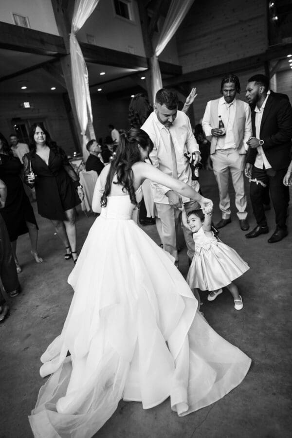 Bride and groom dance with daughter