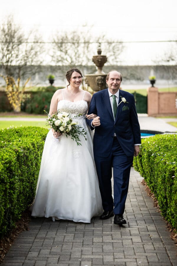 Bride and father walk up the aisle