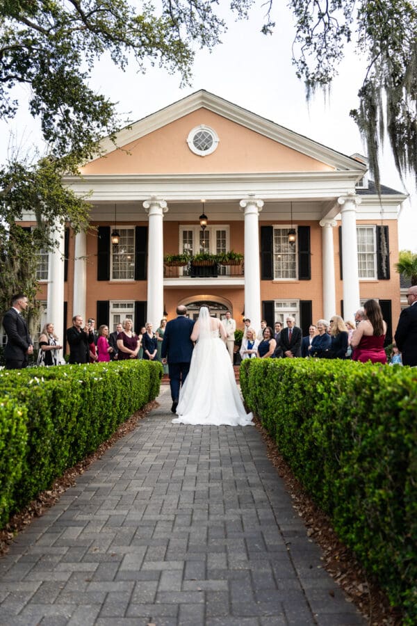 View from behind as bride and father walk up the aisle