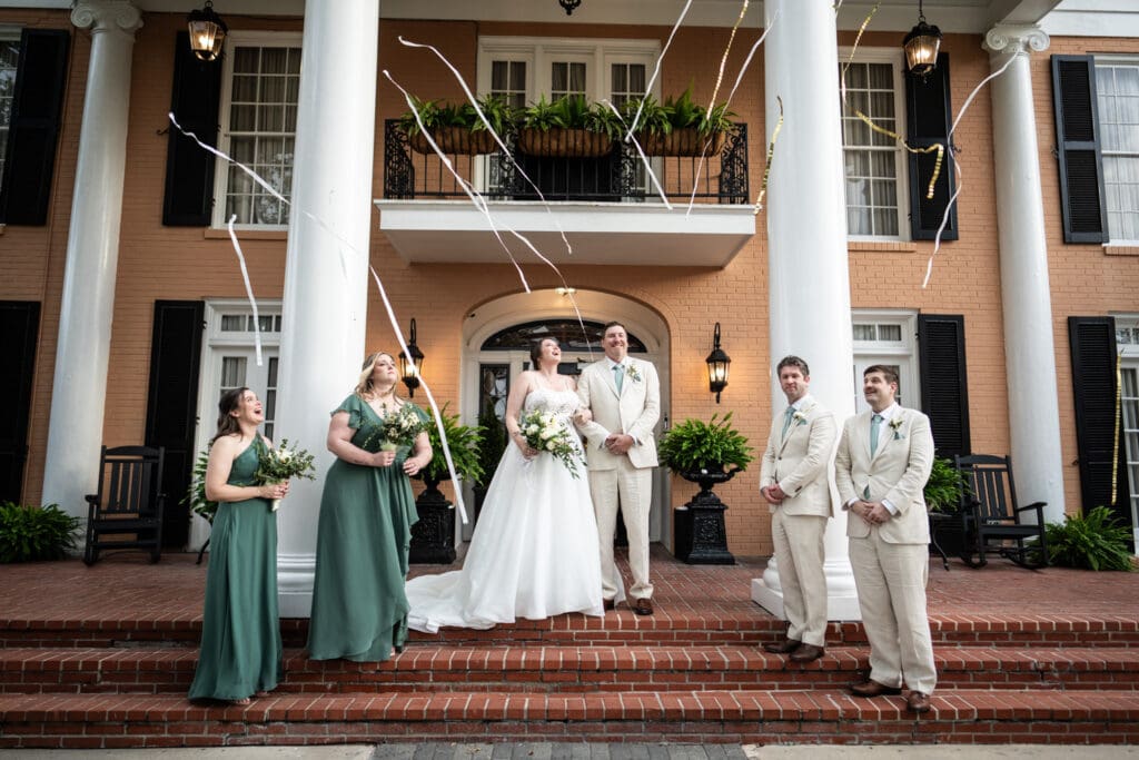 Streamers fall through the air at conclusion of wedding ceremony at Southern Oaks