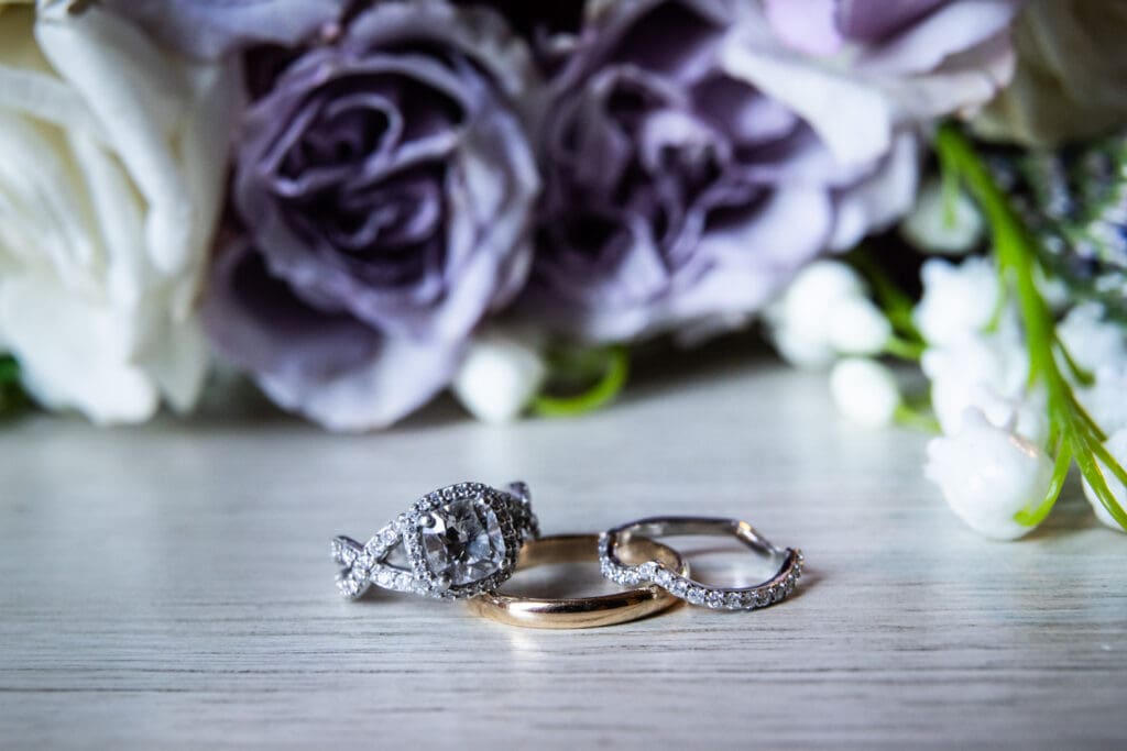 Wedding rings with flowers in the background