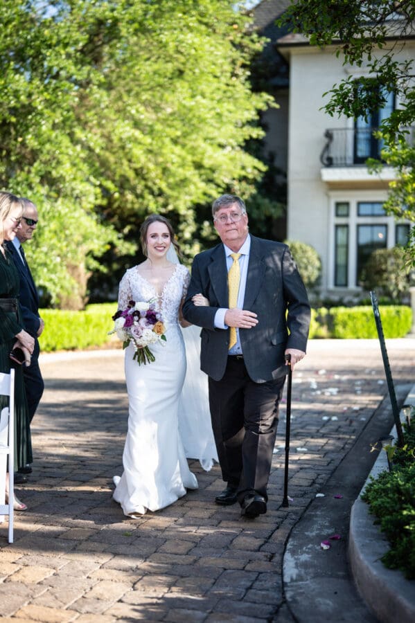Bride and father walk up the aisle