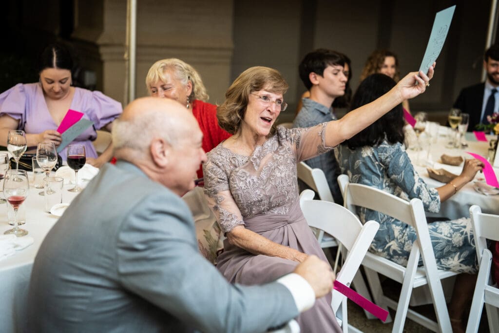 Family members holding up cards during wedding game