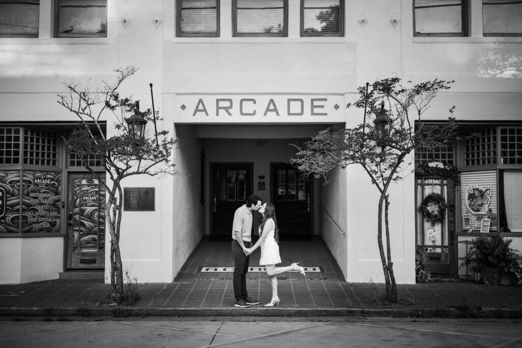 Couple kissing in front of Arcade building in Olde Town Slidell