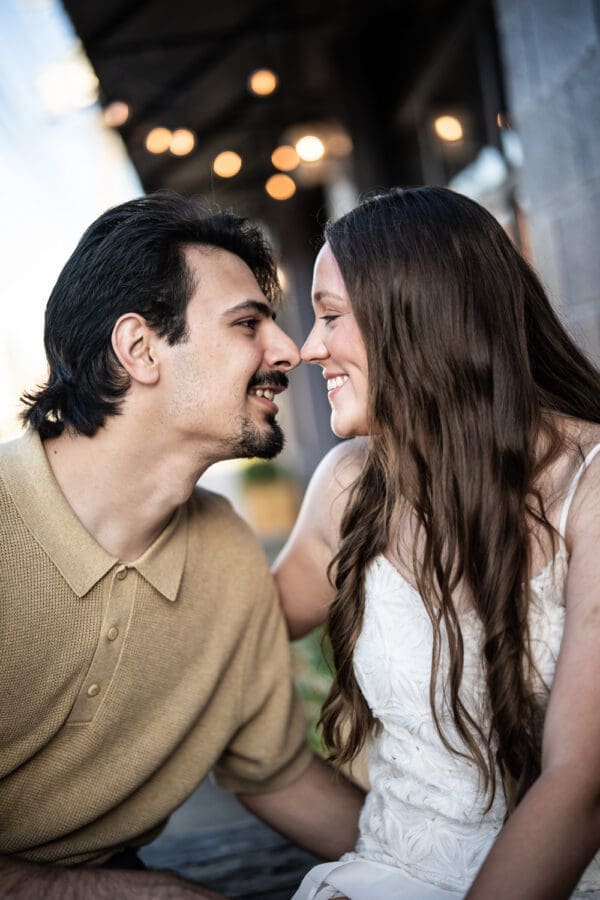 Close-up of couple with lights behind them