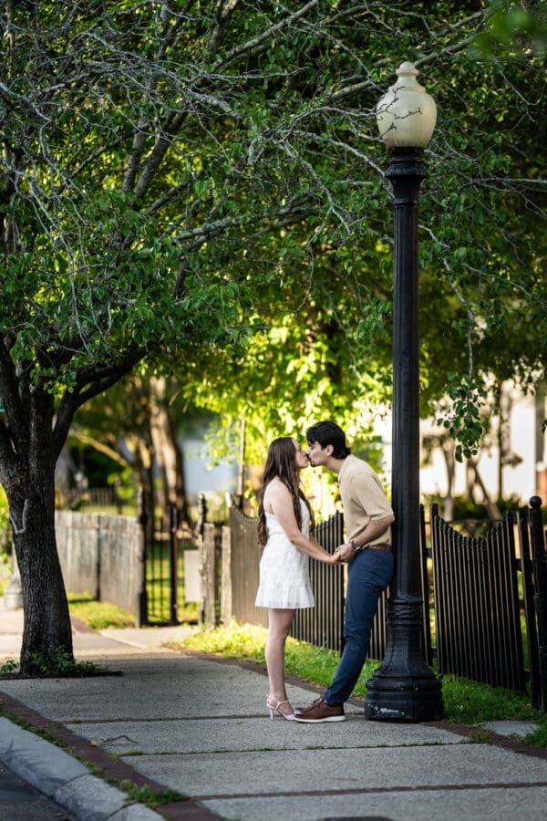 Couple kissing by lamp post in Olde Town Slidell